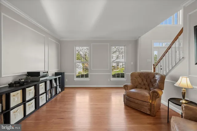 a dining room with furniture a chandelier and window