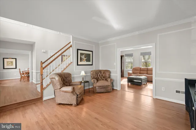 a view of a dining room with furniture wooden floor and chandelier