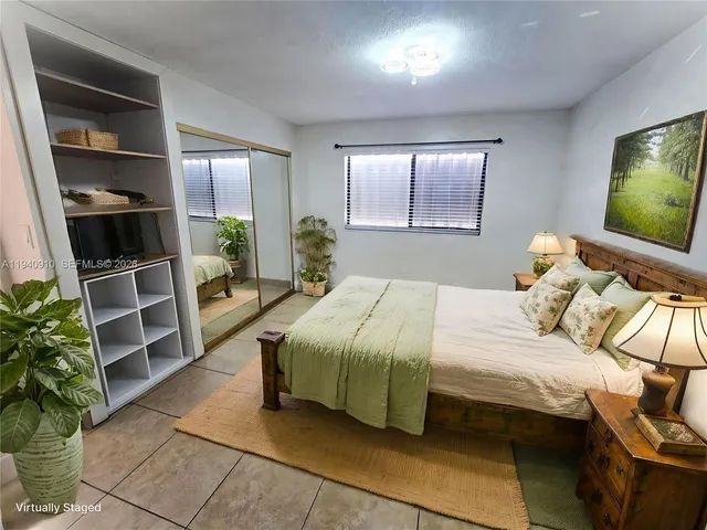 a bedroom with a bed and potted plant with the outer view