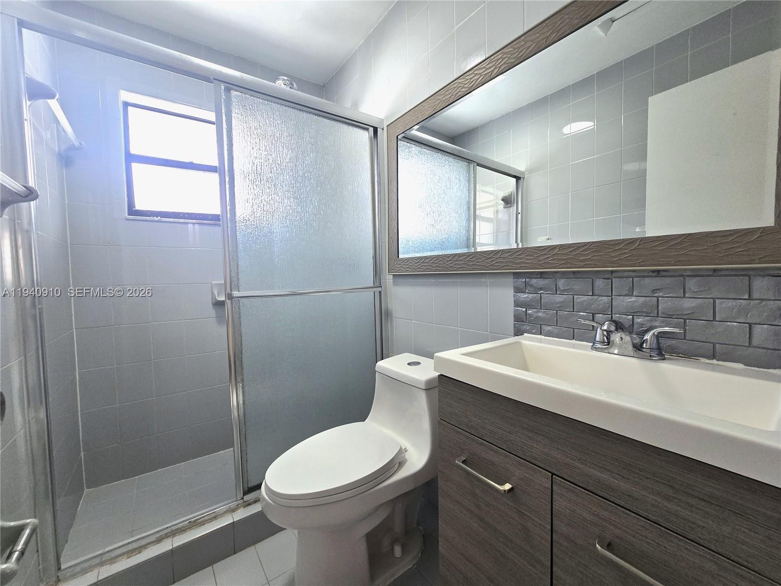 2775 West 61st Street, Unit 203 Hialeah, FL 33016 - Photo 4 of 8 a bathroom with a sink toilet and shower