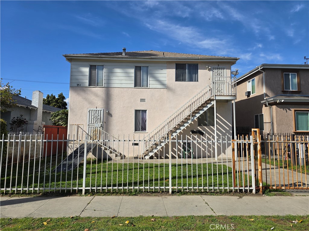 a front view of a house with wooden fence