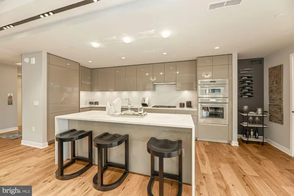a kitchen with a sink stainless steel appliances and cabinets