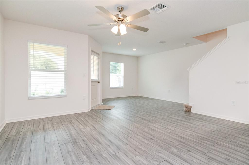 1668 Wynford Circle Tavares, FL 32778 - Photo 11 of 30 an empty room with wooden floor and windows