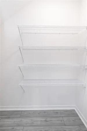 a view of kitchen and hallway with wooden floor