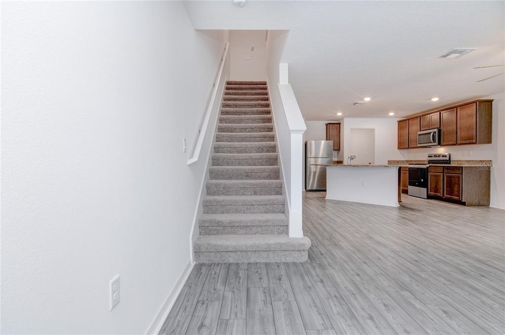 1668 Wynford Circle Tavares, FL 32778 - Photo 16 of 30 a view of kitchen and hallway with wooden floor