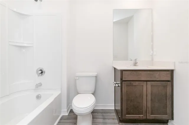 a white bath tub with shower