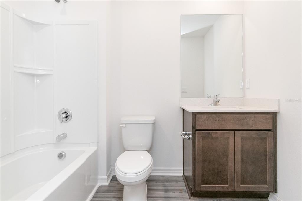 1668 Wynford Circle Tavares, FL 32778 - Photo 19 of 30 a bathroom with a sink toilet and shower