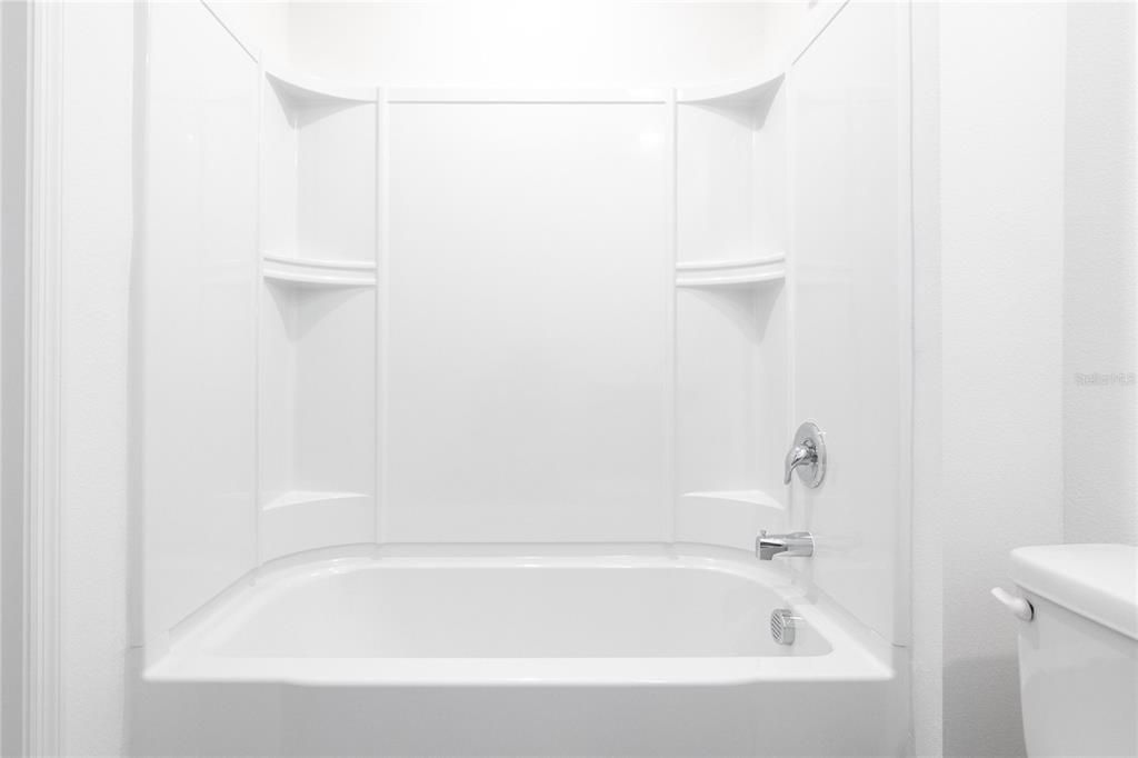 1668 Wynford Circle Tavares, FL 32778 - Photo 20 of 30 a white bath tub with shower