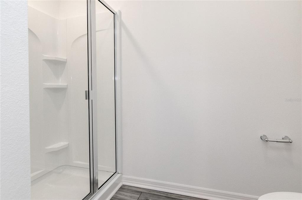 1668 Wynford Circle Tavares, FL 32778 - Photo 25 of 30 a bathroom with a granite countertop shower