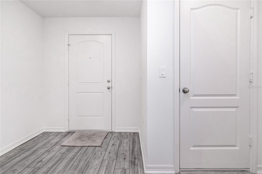 1668 Wynford Circle Tavares, FL 32778 - Photo 5 of 30 an empty room with wooden floor