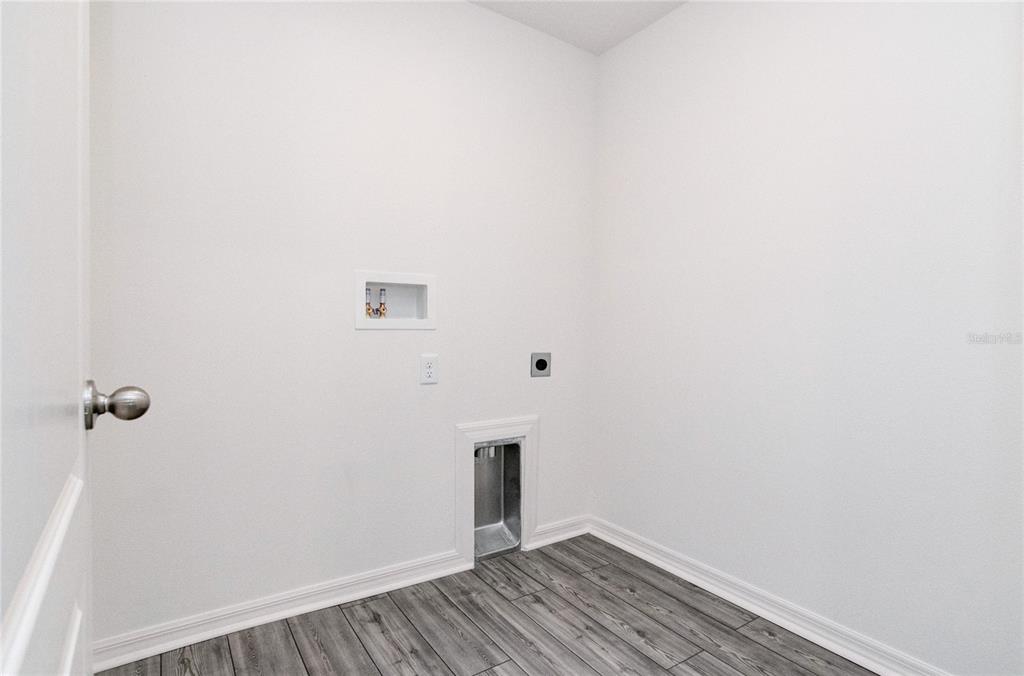 1668 Wynford Circle Tavares, FL 32778 - Photo 9 of 30 a view of a room with wooden floor