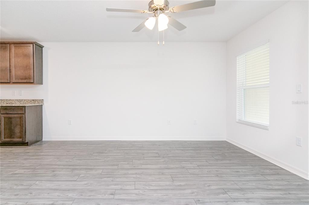 1668 Wynford Circle Tavares, FL 32778 - Photo 10 of 30 a view of an empty room with wooden floor and a window