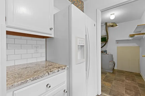 a kitchen with a sink appliances and cabinets