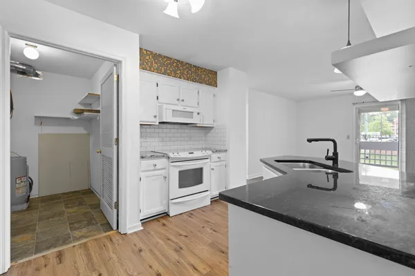 a view of a kitchen with a sink stainless steel appliances and cabinets