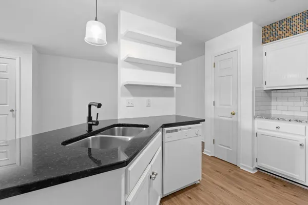 a view of walk in closet with wooden floor
