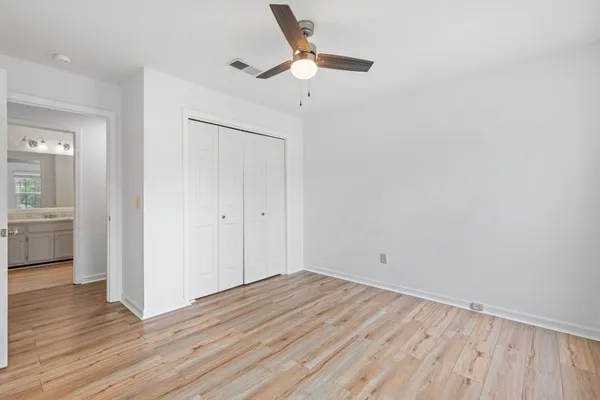 a bathroom with a granite countertop sink a toilet and a bathtub