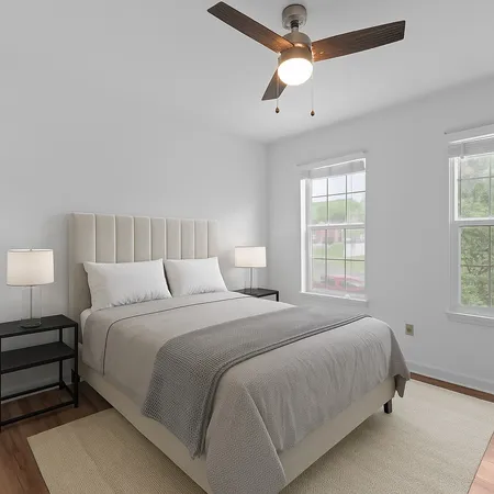 a bedroom with bed and a window