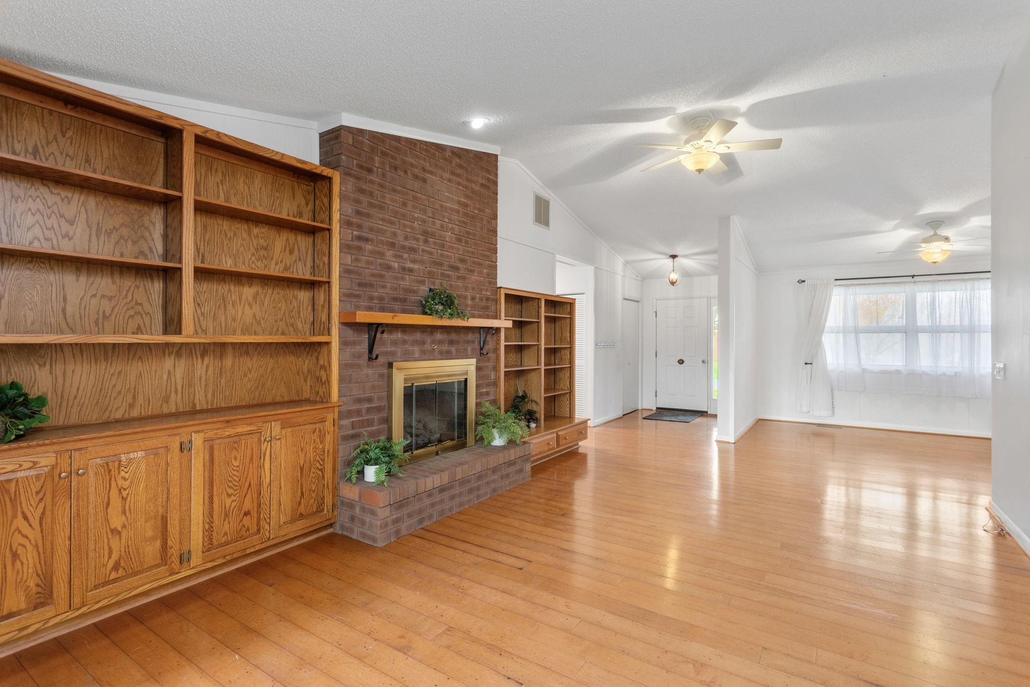 3210 Arrowhead Road Harrisonburg, VA 22801 - Photo 7 of 44 a view of an empty room with a fireplace and a window