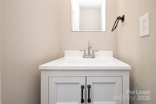 a bathroom with a sink a vanity and a mirror