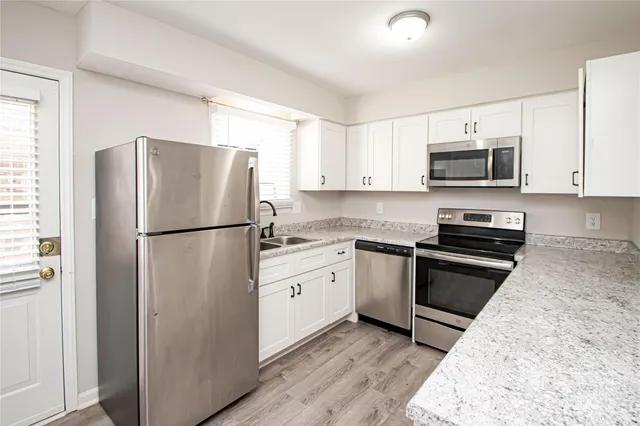 a kitchen with a refrigerator stove and microwave