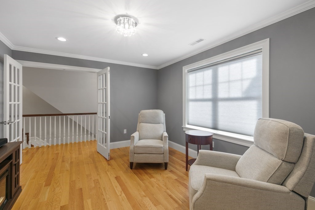 27 Webster Road Lexington, MA 02421 - Photo 17 of 42 a bedroom with furniture and wooden floor