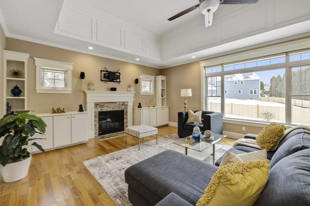 27 Webster Road Lexington, MA 02421 - Photo 2 of 42 a living room with furniture large window and a fireplace