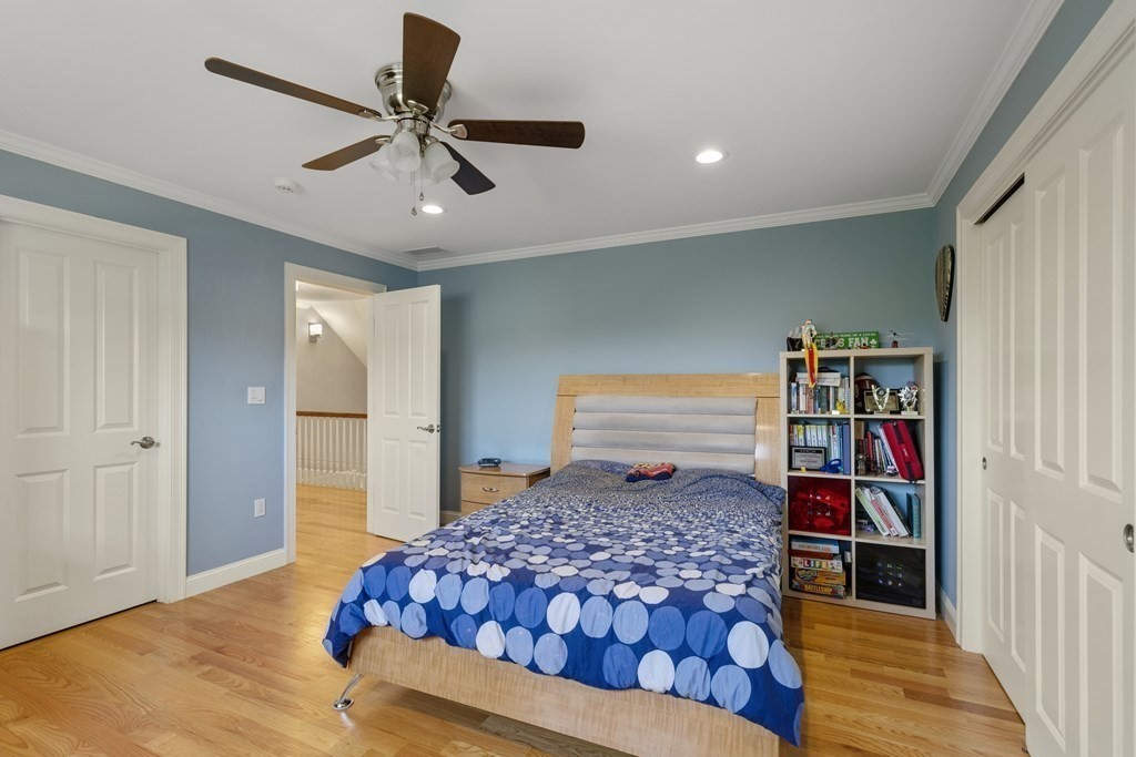 27 Webster Road Lexington, MA 02421 - Photo 27 of 42 a bedroom with a large bed and a chandelier