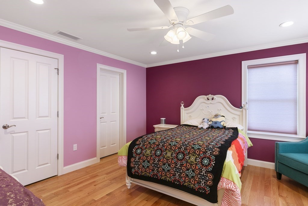27 Webster Road Lexington, MA 02421 - Photo 28 of 42 a bedroom with a bed dresser and wooden floor