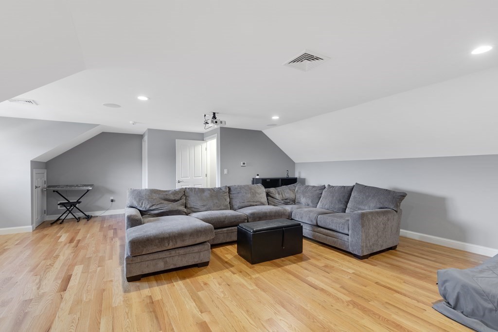 27 Webster Road Lexington, MA 02421 - Photo 30 of 42 a living room with furniture and a wooden floor