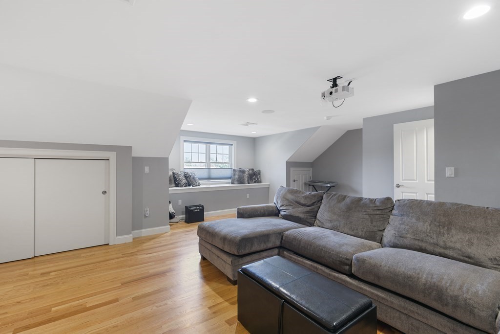 27 Webster Road Lexington, MA 02421 - Photo 32 of 42 a living room with furniture and a wooden floor