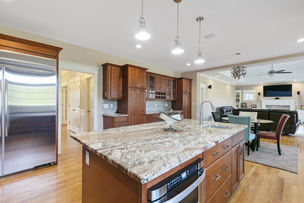 27 Webster Road Lexington, MA 02421 - Photo 8 of 42 a kitchen with stainless steel appliances granite countertop a kitchen island a stove and a sink