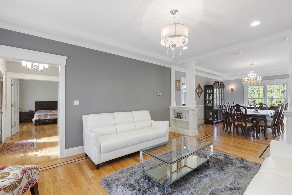 27 Webster Road Lexington, MA 02421 - Photo 10 of 42 a living room with furniture and a chandelier