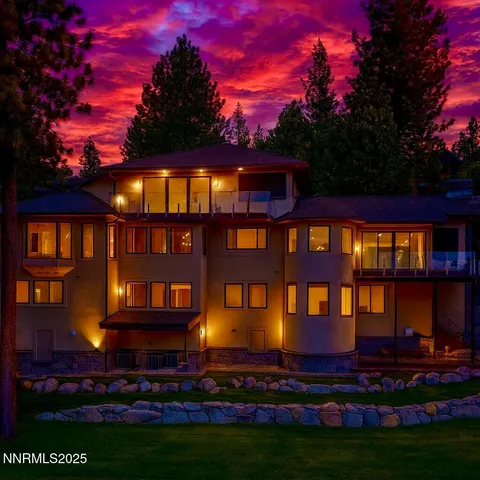 a view of a dining room with furniture large windows and wooden floor