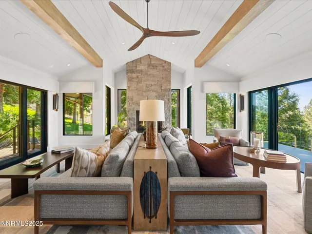 a living room with furniture pool table and a flat screen tv