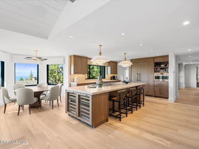 a dining room with furniture a rug and a potted plant