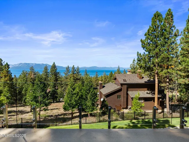 a spacious bedroom with a bed and large windows