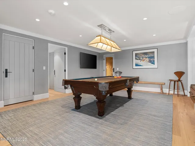 a view of a wooden house with a tree in the background