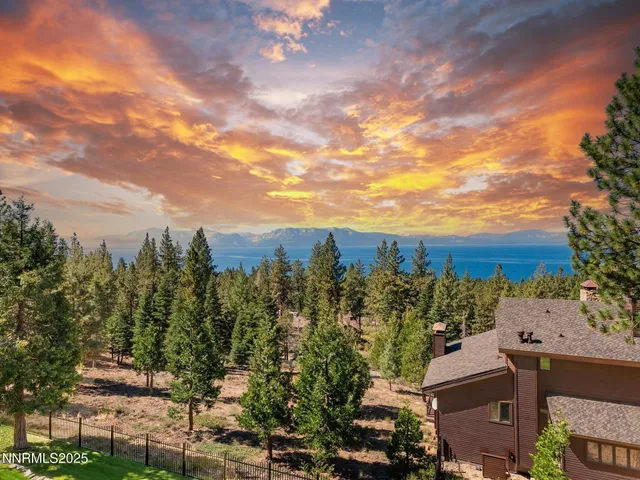 a living room with furniture a fireplace and a large window