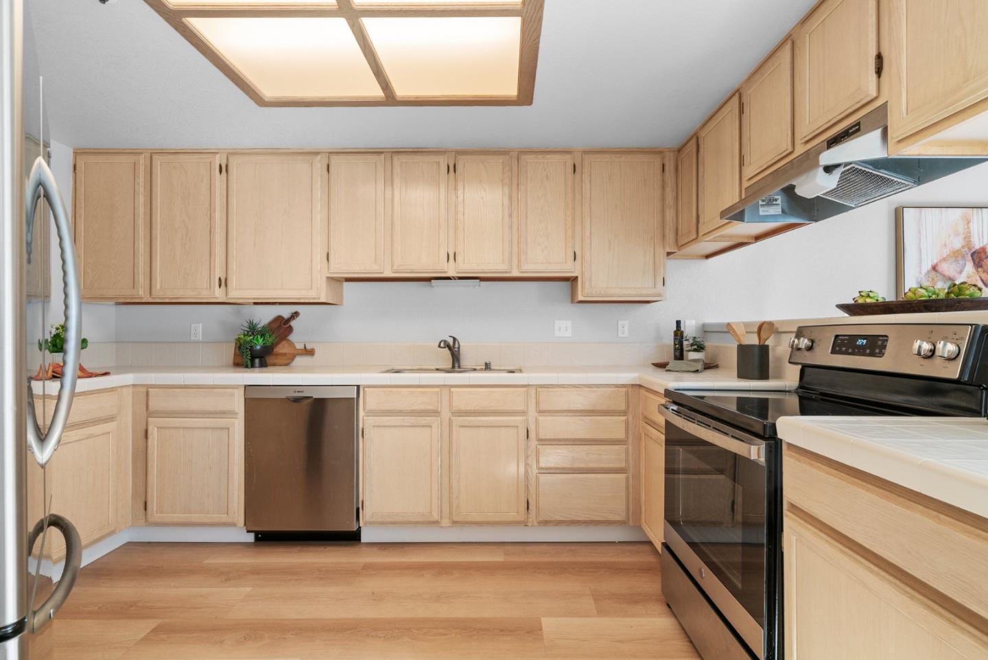 355 Village Creek Road Aptos, CA 95003 - Photo 11 of 41 a kitchen with granite countertop white cabinets and white appliances