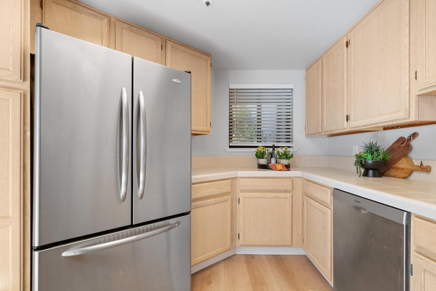 355 Village Creek Road Aptos, CA 95003 - Photo 13 of 41 a kitchen with a refrigerator and white cabinets