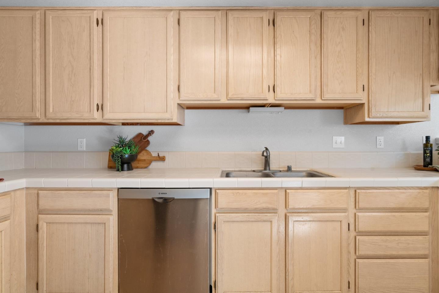 355 Village Creek Road Aptos, CA 95003 - Photo 14 of 41 a kitchen with granite countertop white cabinets and white appliances