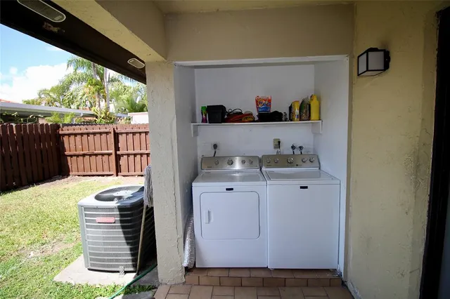 a kitchen with a sink and wooden floor