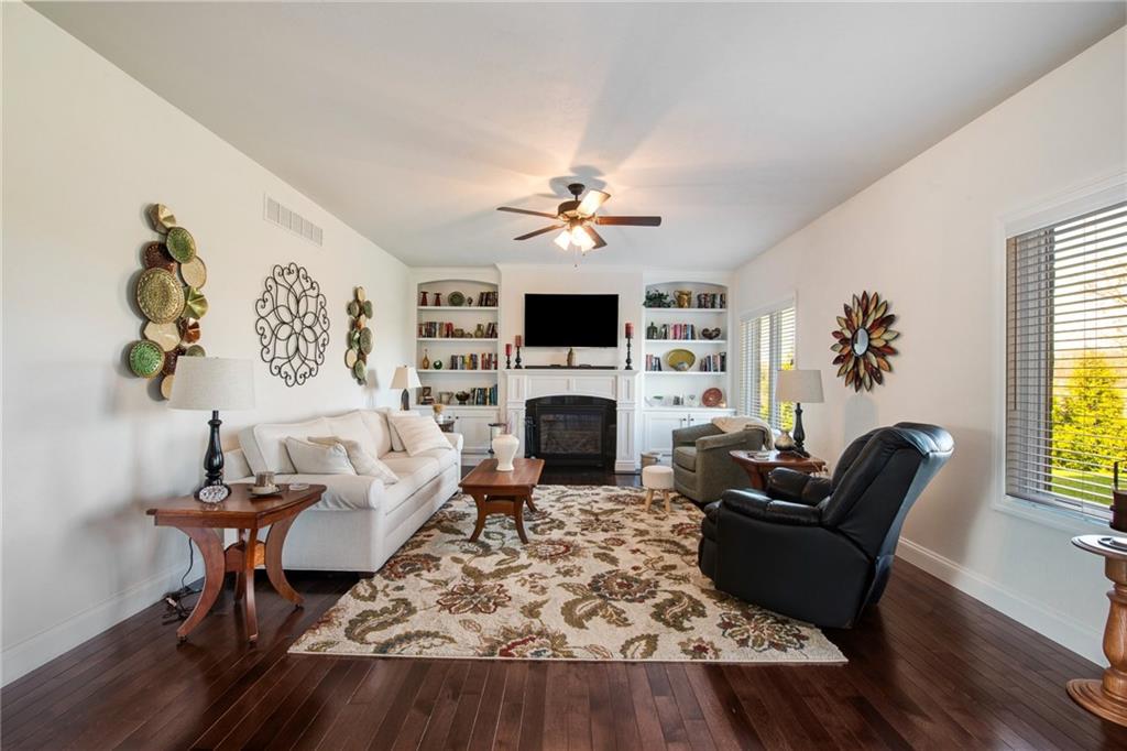 7372 Sierra Drive Irwin, PA 15642 - Photo 15 of 32 a living room with furniture a fireplace and a flat screen tv