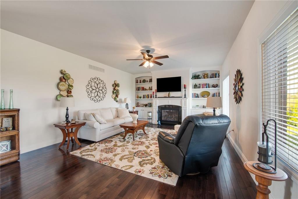 7372 Sierra Drive Irwin, PA 15642 - Photo 16 of 32 a living room with furniture a fireplace and a flat screen tv