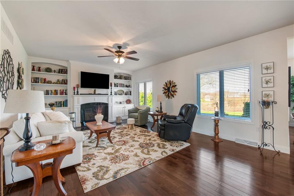 7372 Sierra Drive Irwin, PA 15642 - Photo 17 of 32 a living room with furniture a fireplace and a flat screen tv