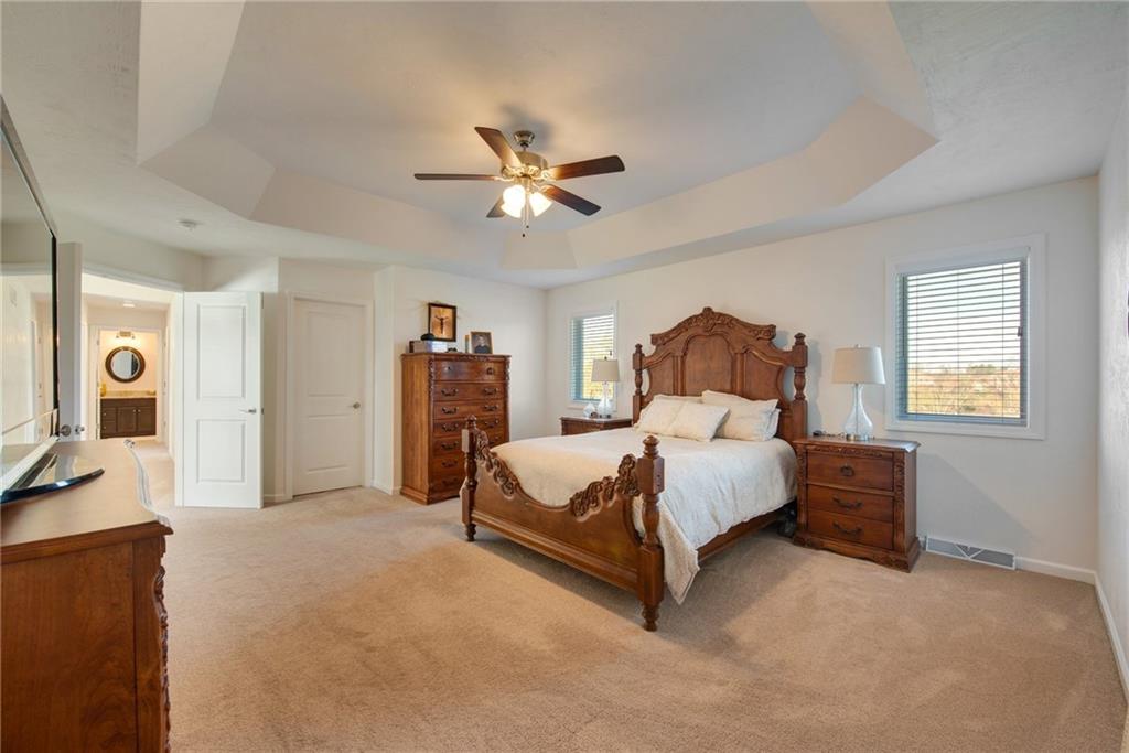 7372 Sierra Drive Irwin, PA 15642 - Photo 20 of 32 a spacious bedroom with a bed and ceiling fan
