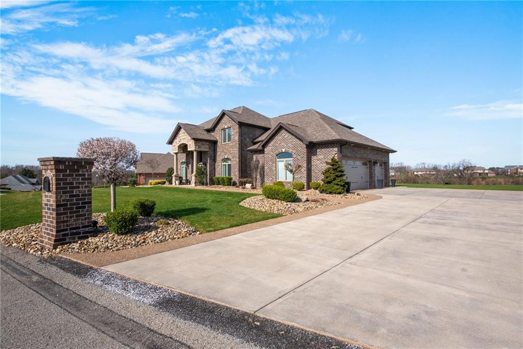 7372 Sierra Drive Irwin, PA 15642 - Photo 2 of 32 a front view of a house with a yard and potted plants