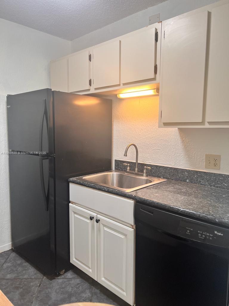 17 Crossings Circle, Unit E Boynton Beach, FL 33435 - Photo 11 of 20 a kitchen with appliances a sink and cabinets