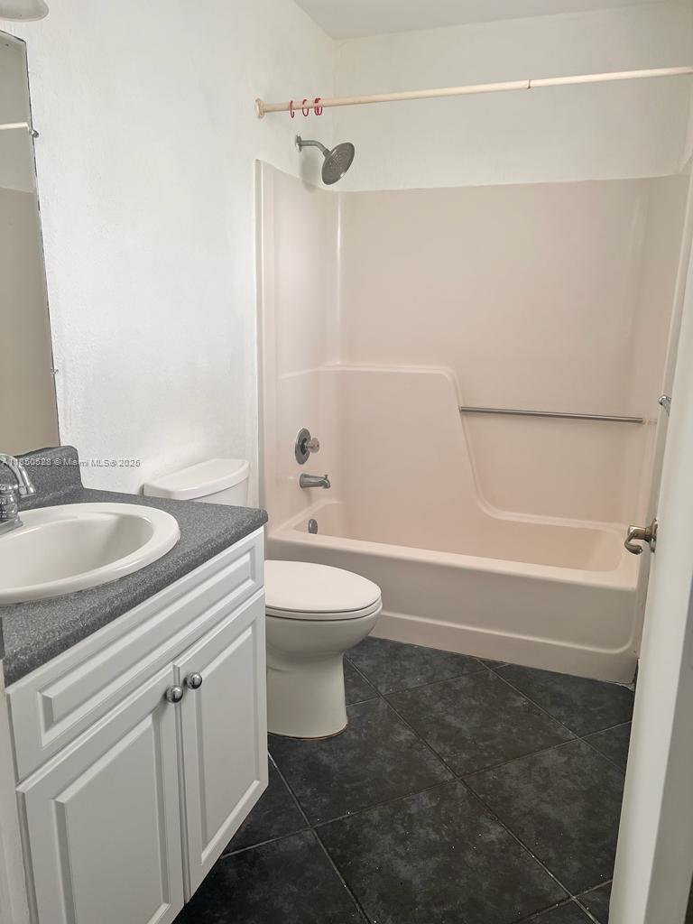 17 Crossings Circle, Unit E Boynton Beach, FL 33435 - Photo 18 of 20 a bathroom with a sink a toilet and shower