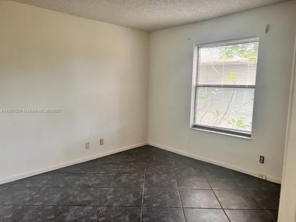 a view of an empty room with brick walls